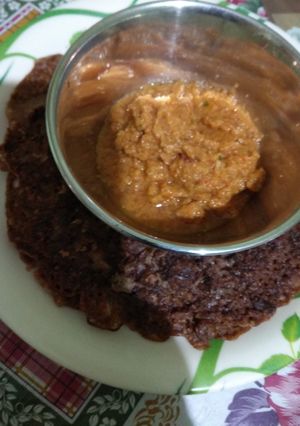 A picture of Ragi dosa with tomato, onion chutney.