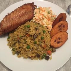 A picture of Fried rice, fried turkey with coleslaw and dodo ( fried plantain.
