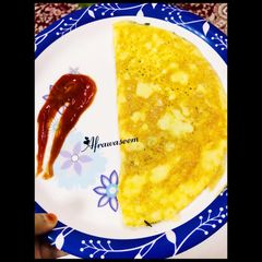 A picture of Soufflé omelette with dash of fenugreek leaves.