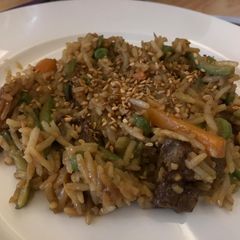 A picture of Fried rice with veggies and meat.