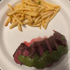 A picture of Filet Steak with Herb Sauce and French Fries.