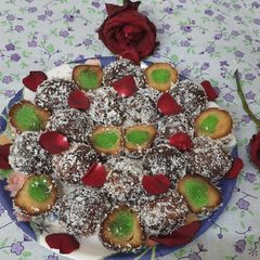 Stuff gulab jamun coated with dry coconut powder A picture of Stuff gulab jamun coated with dry coconut powder.