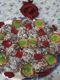 A picture of Stuff gulab jamun coated with dry coconut powder.