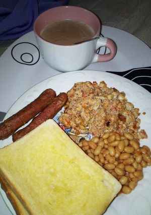 A picture of Toasted Bread, Egg with Sardine Sauce, Baked Beans with Sausage.