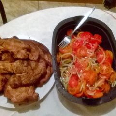 A picture of Braai pork meat on charcoal.