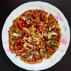 A picture of Gobi pizza with red sauce.