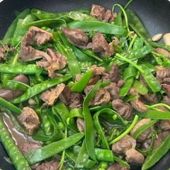 A picture of Stir-Fry Combining Crunchy Snow Peas and Scored Gizzards.