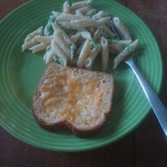 A picture of Broccoli alfredo with garlic bread.