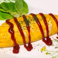 A picture of Japanese Egg Wrapped Tomato Chicken Rice (Omu Rice).