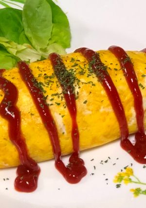 A picture of Japanese Egg Wrapped Tomato Chicken Rice (Omu Rice).