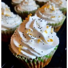 A picture of Gluten-free Oats Lemon Poppy seeds Cupcake + Srikhand Frosting.