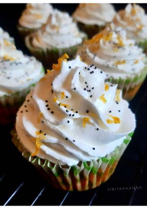 A picture of Gluten-free Oats Lemon Poppy seeds Cupcake + Srikhand Frosting.