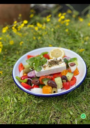 A picture of Vegan Greek Salad with green herbs 🌱🌿.