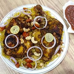 A picture of Chicken Mandi with sauce.