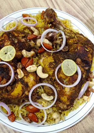 A picture of Chicken Mandi with sauce.