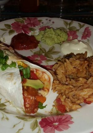 A picture of Mexican Burritos with Mexican Rice.