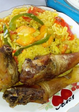 A picture of Garnished rice with fried chicken.