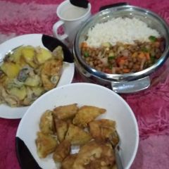 A picture of Rice,fried beans,fried egg mixed with potatoes,and indomie cake.