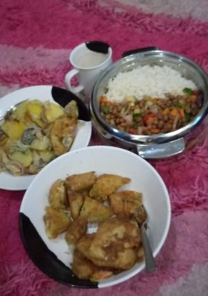 A picture of Rice,fried beans,fried egg mixed with potatoes,and indomie cake.