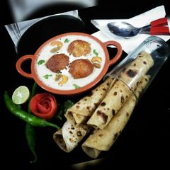 A picture of Mughlai Malai Kofta Curry(Malai kofta in white gravy).