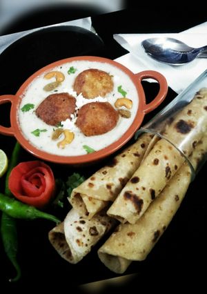 A picture of Mughlai Malai Kofta Curry(Malai kofta in white gravy).