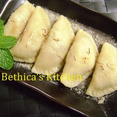 A picture of Bhapa Puli Pithe (Traditional Bengali Sweet in a Fusion Style).
