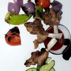 A picture of Bbq chops with veggies.