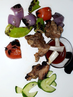A picture of Bbq chops with veggies.