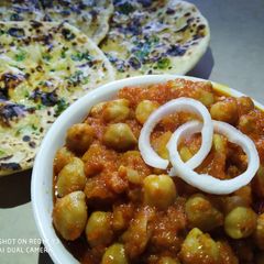 A picture of Chole with aloo kulcha.