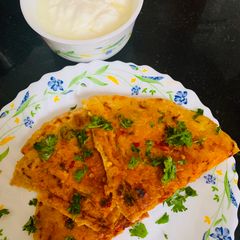 A picture of Stuffed Leftover Rice Paratha topped with Schezwan Sauce.