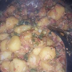 A picture of Porridge potatoes with egg and meat.