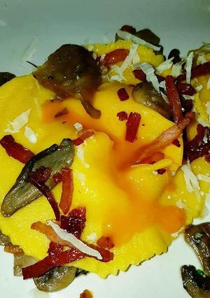 A picture of Ravioli with Runny Egg Yolk, Mixed Mushrooms, and Crispy Speck.