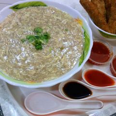 A picture of Chicken soup with chicken sticks.