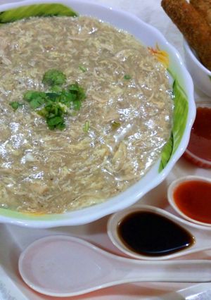 A picture of Chicken soup with chicken sticks.
