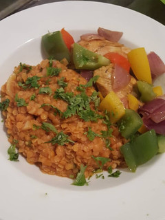 A picture of Lentil porridge with sweet peppered chicken breast.