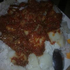 A picture of Rice &stew with aresh.