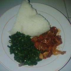 A picture of Ugali,fried meat and spinach.