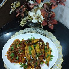 A picture of Grilled fish with onion tomatoes.