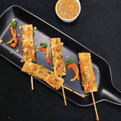 A picture of Paneer Satay in peanut sauce.