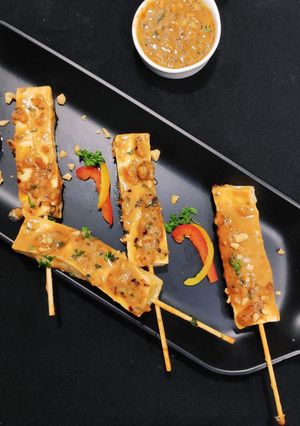A picture of Paneer Satay in peanut sauce.