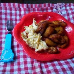 A picture of Scrambled eggs and fried plantain.