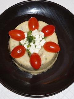 A picture of Polenta with cremini mushrooms and feta cheese.