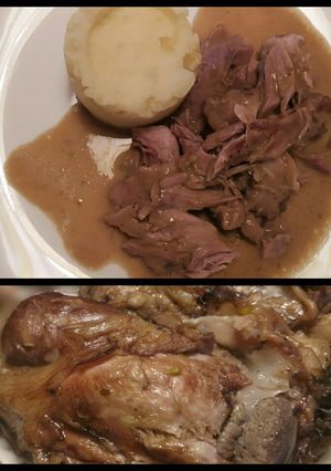 A picture of Pork hock with in season asparagus sauce.