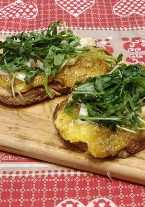 A picture of Bruschetta with Caramelized Figs, Toma Cheese, and Arugula.