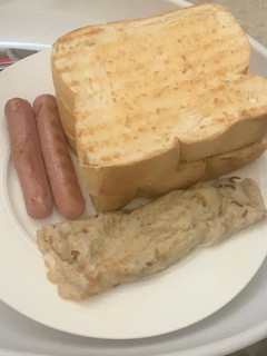 A picture of Eggs sausage and toasted bread.