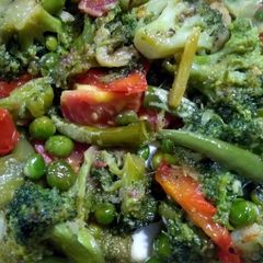 A picture of Broccoli and bell peppers stir fry.