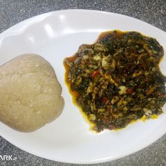 A picture of Eba and bitter leaf soup.