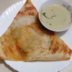 A picture of Masala dosai with coconut chutney.