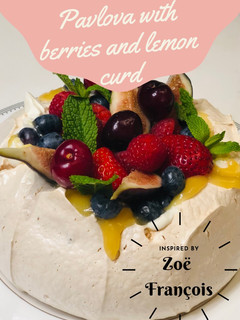 A picture of Pavlova with berries and lemon curd.