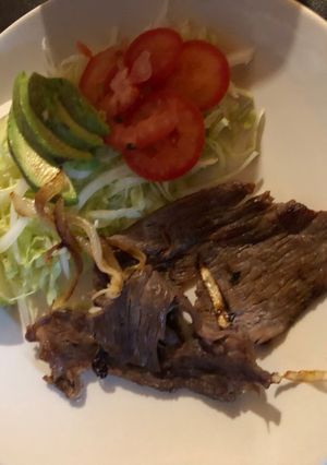 Una foto de Tasajo encebollado